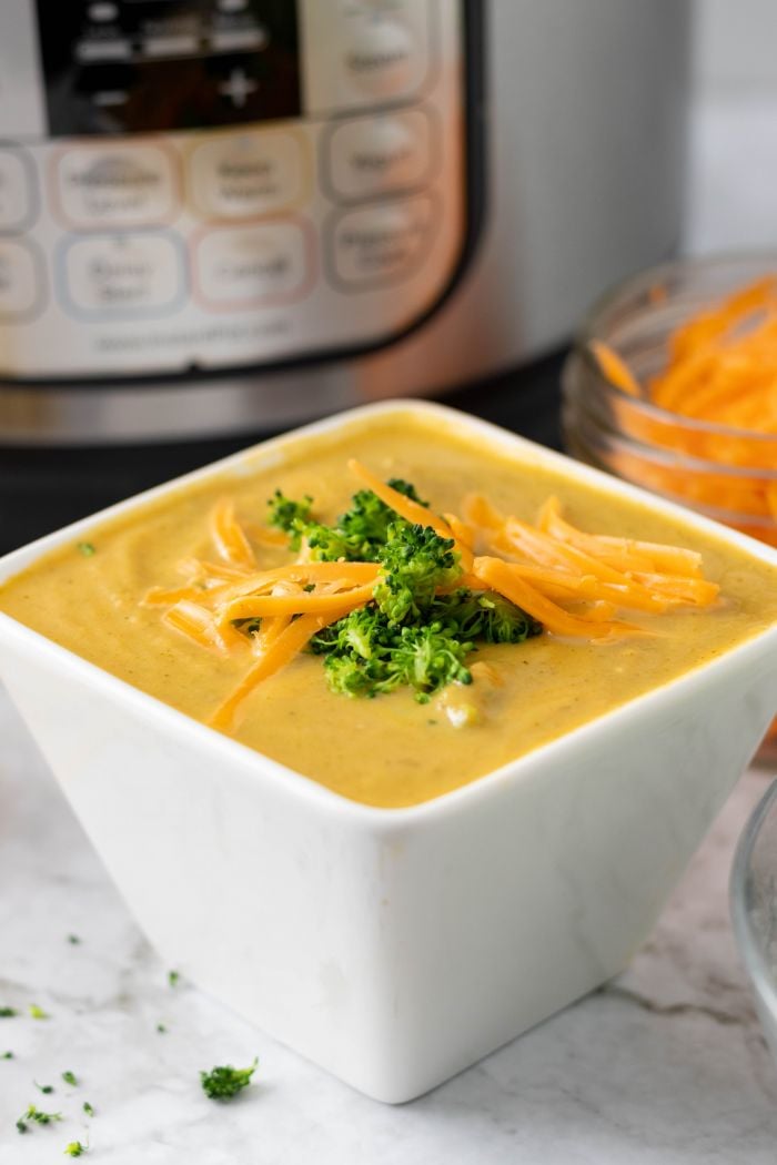 broccoli cheddar soup in a square bowl, the instant pot in the background